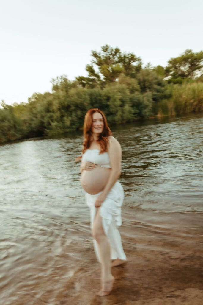 Family maternity session at the Lower Salt River near Phoenix with parents and toddler exploring the shoreline.