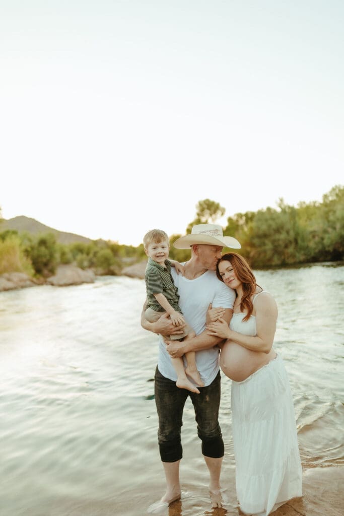 Family of three celebrating pregnancy during a Salt River maternity session near Gilbert and Phoenix.