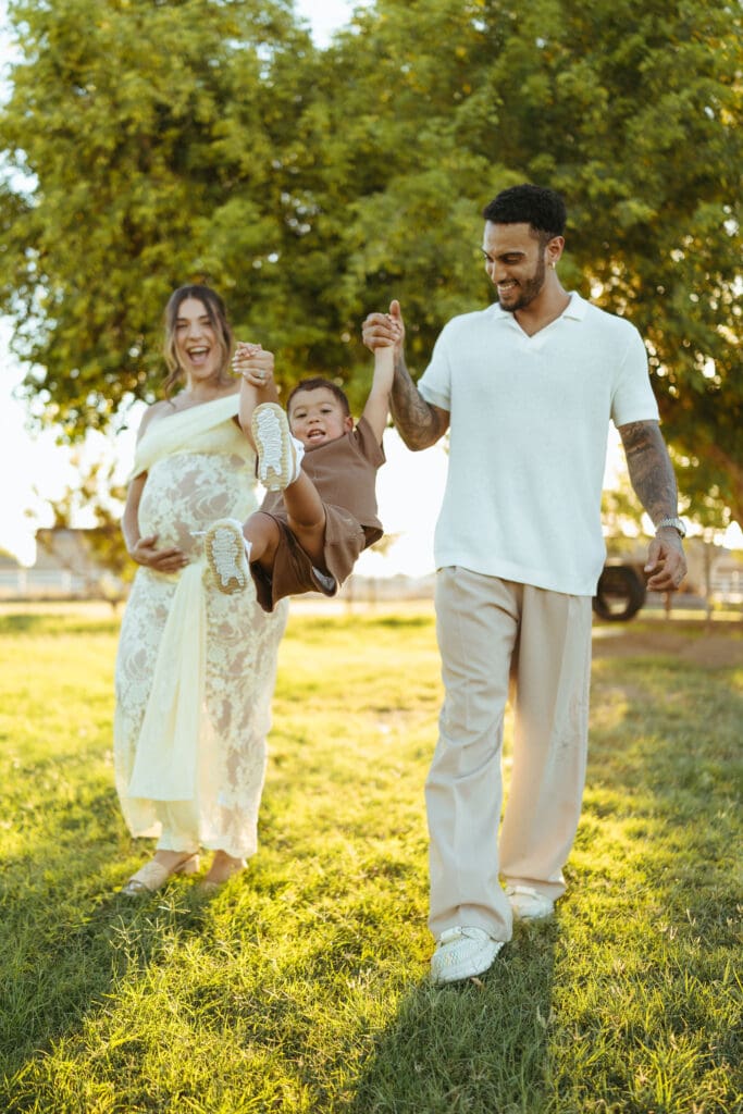 Family walking together during a golden hour maternity session at Patch of Paradise AZ in Gilbert, Arizona.