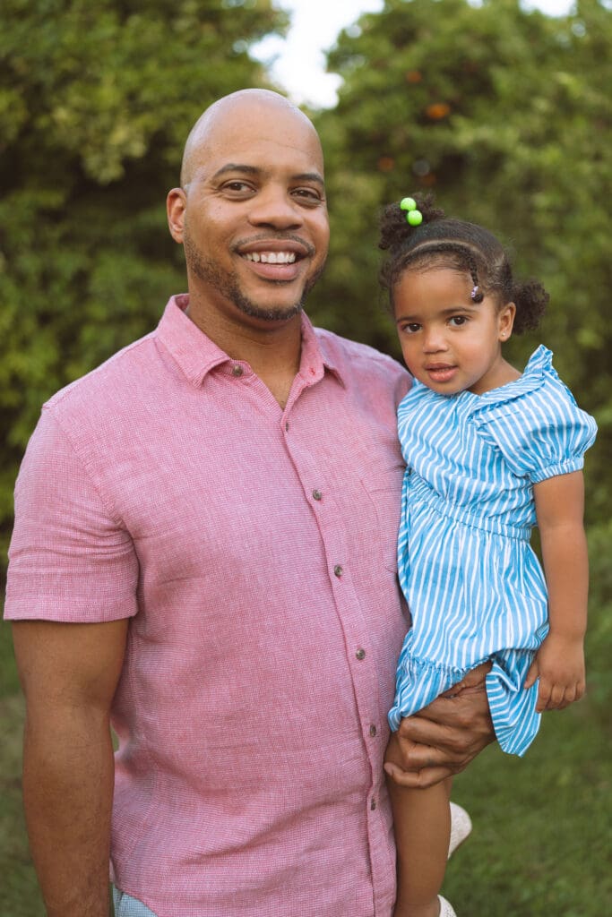 Portrait of a father and daughter during a family photography session at Hagen Farms orchard.