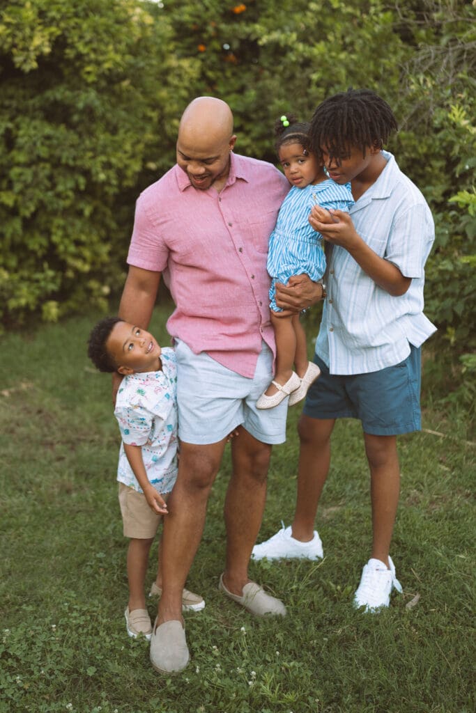 Father holding his children during a relaxed outdoor family session at Hagen Farms near Gilbert and Queen Creek.