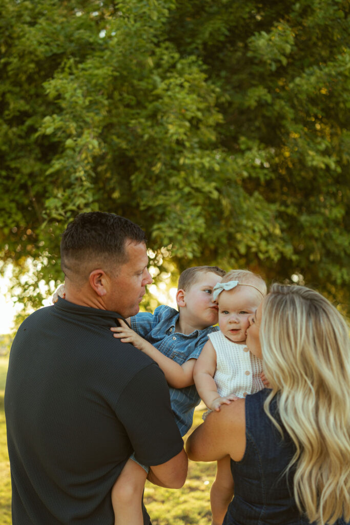 Mom and dad cuddling their children during a relaxed lifestyle family photography session in Gilbert.