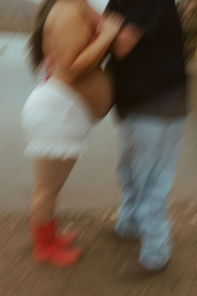 Creative motion blur photograph of an expecting couple embracing during a maternity session at Butcher Jones Beach in Mesa, Arizona.