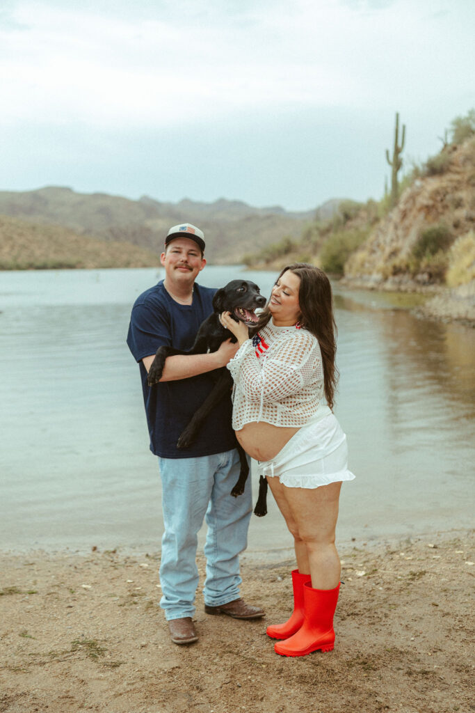 Mesa maternity photographer capturing an expecting couple with their dog during a maternity session at Butcher Jones Beach.