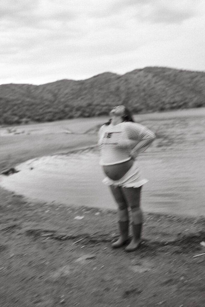 Artistic black and white motion blur portrait of an expecting mother during a creative maternity session in Mesa, Arizona.