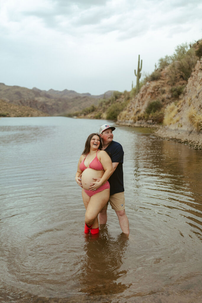 Couple sharing a quiet moment while standing in the water during a maternity session at Saguaro Lake in Mesa, Arizona.