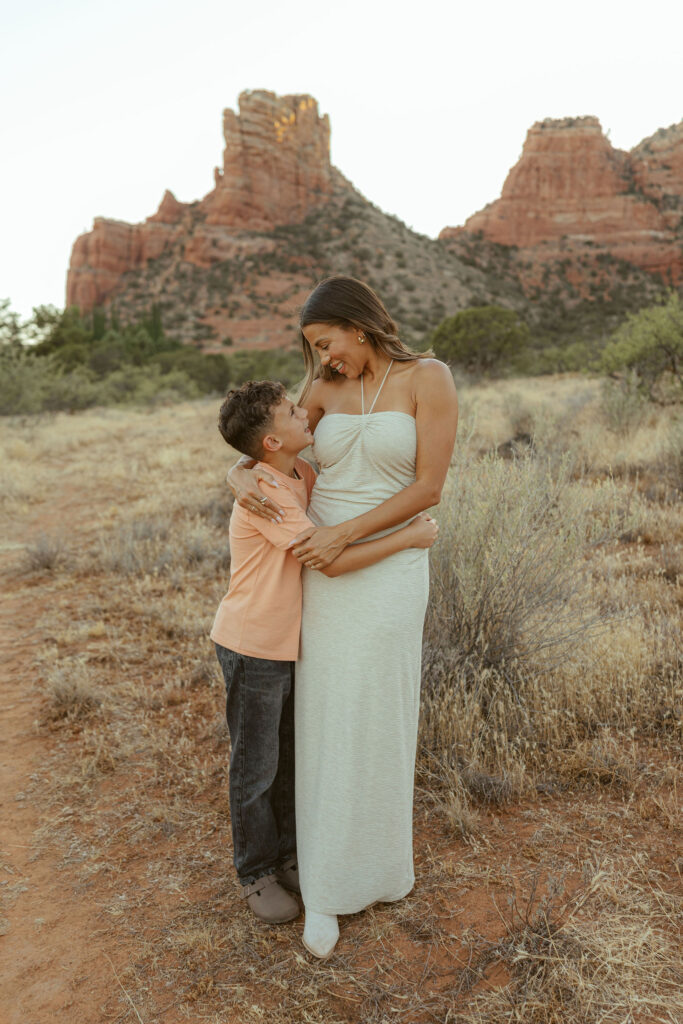 Mother hugging her son during a relaxed outdoor family photography session in Sedona, Arizona.