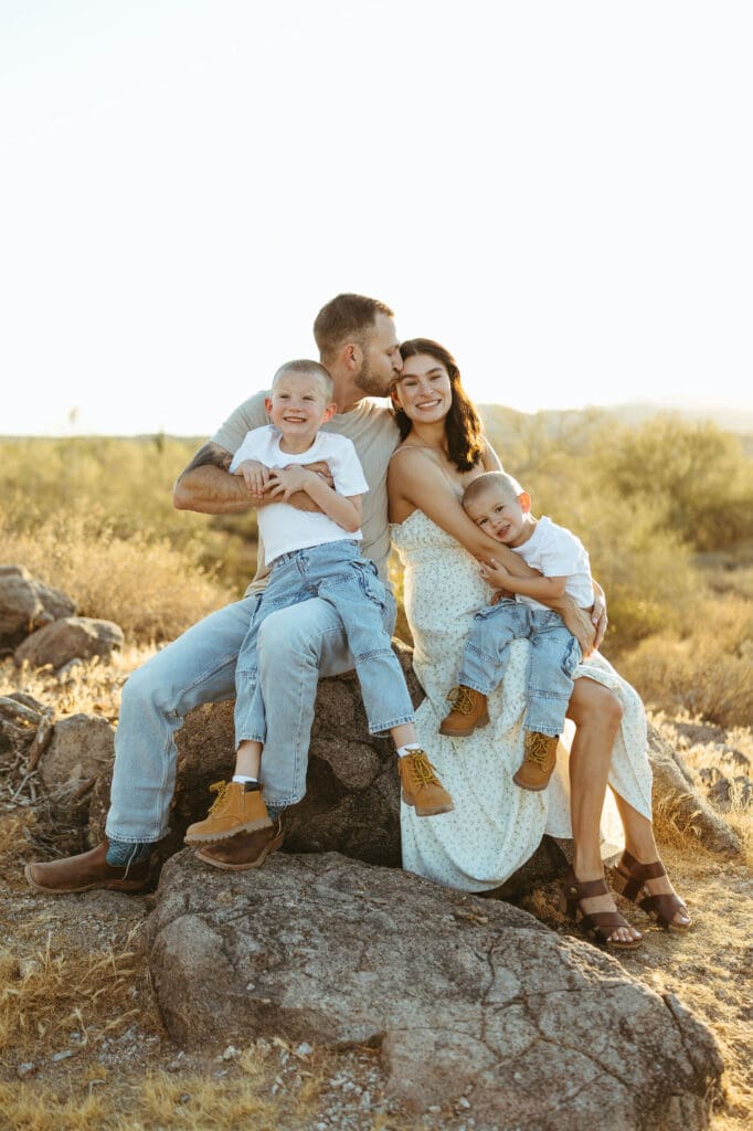 Family pregnancy announcement photos with two brothers in the Arizona desert near the Superstition Mountains