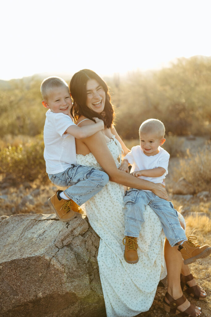 Mother holding her two sons during a Scottsdale pregnancy announcement photo session