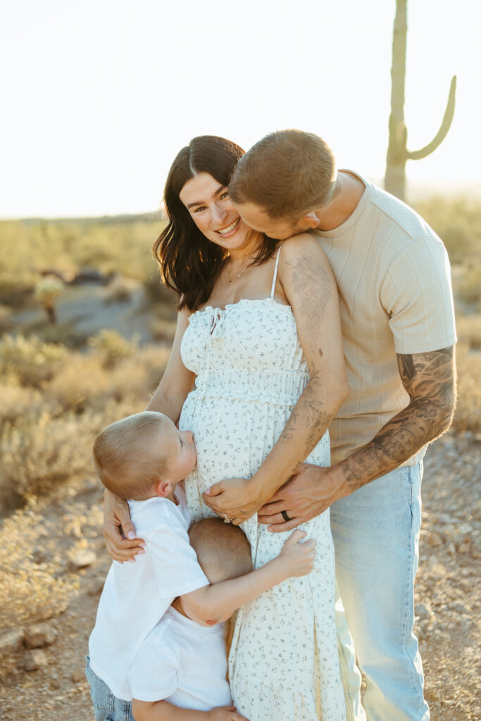 Expecting parents with their two boys during a Scottsdale desert maternity photography session