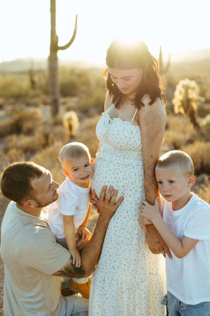 Family celebrating a pregnancy announcement at the Superstition Mountains in Arizona
