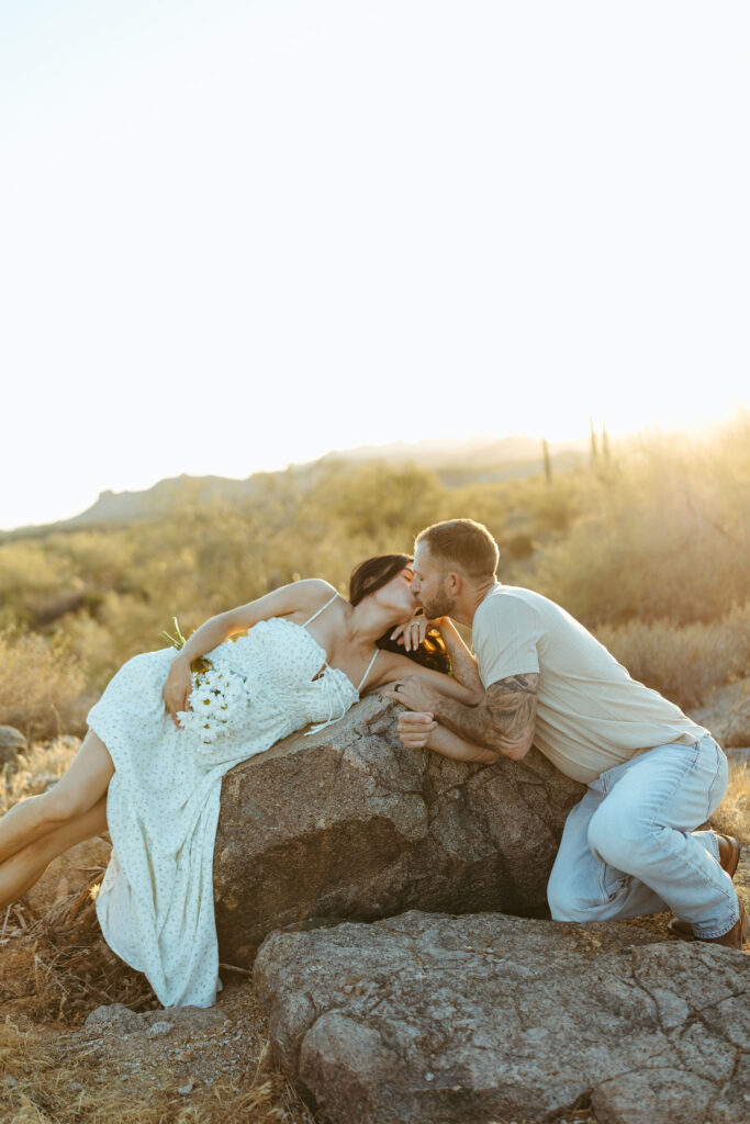 Romantic maternity photo of expecting parents at the Superstition Mountains during golden hour