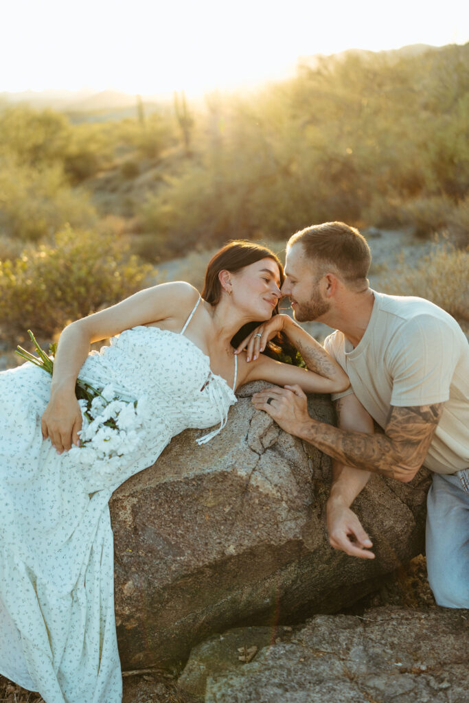 Romantic maternity photo of expecting parents at the Superstition Mountains during golden hour