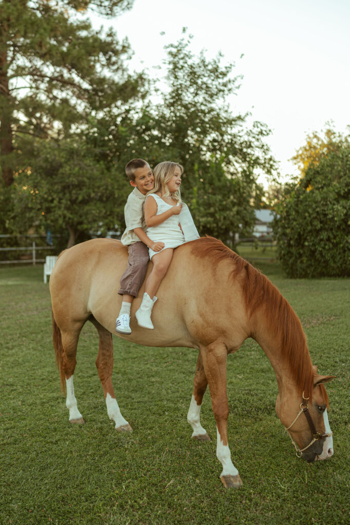 Kids with horses photography documenting siblings riding their gentle family horse during a lifestyle maternity session in Arizona.
