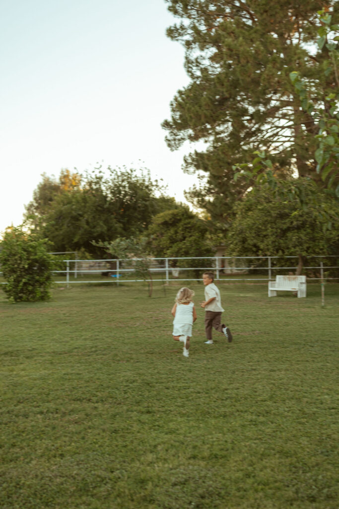 Lifestyle maternity photography featuring an expecting family with their horse during a golden hour pregnancy announcement session in Gilbert, Arizona.