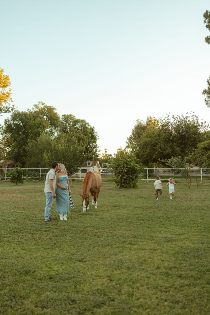 Little girl holding a chicken during a family farm maternity session at Floyd Family Farms in Gilbert, Arizona.