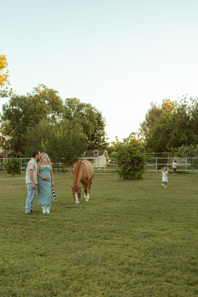 Horse lover maternity photos capturing an expecting mom leading her children on horseback during a family session at Floyd Family Farms.