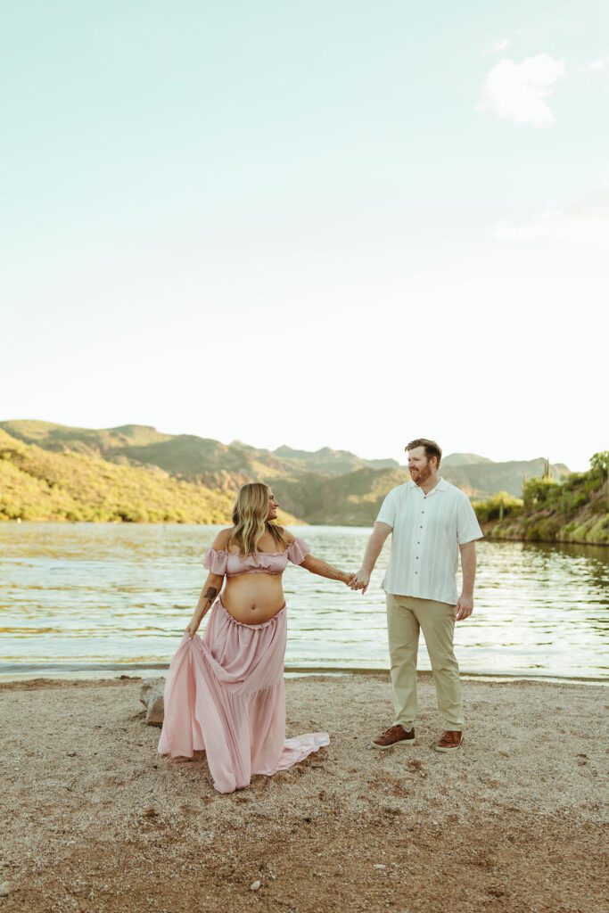 Expecting couple along the Saguaro Lake shoreline during their Butcher Jones maternity session in Mesa, Arizona