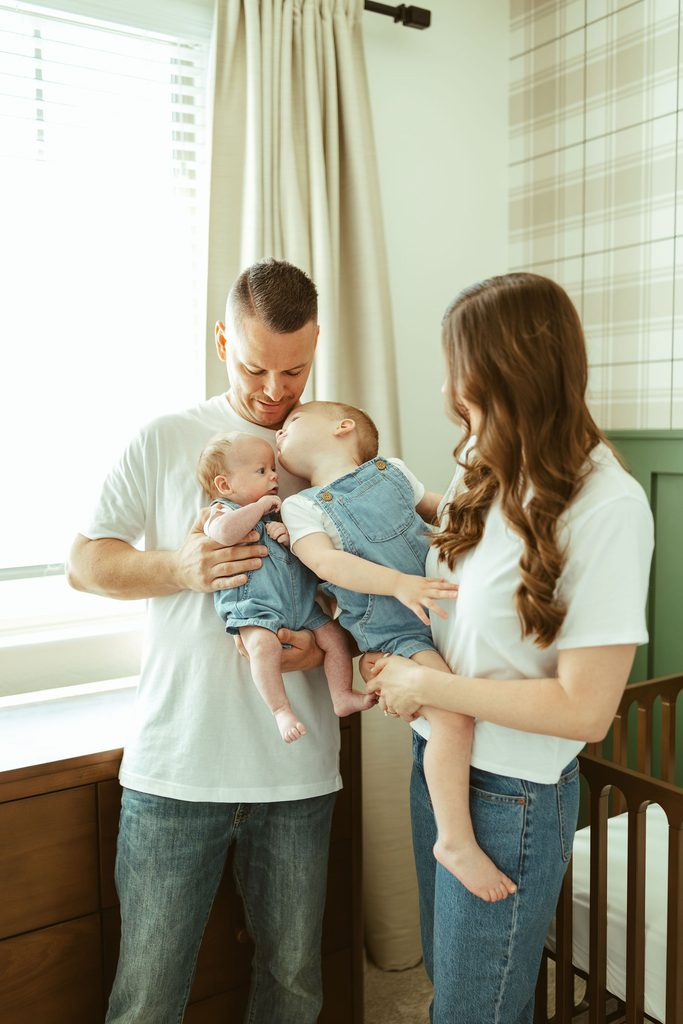 Gilbert newborn photographer capturing newborn siblings lying together on a bed during a beautiful in-home newborn session in Gilbert, Arizona.