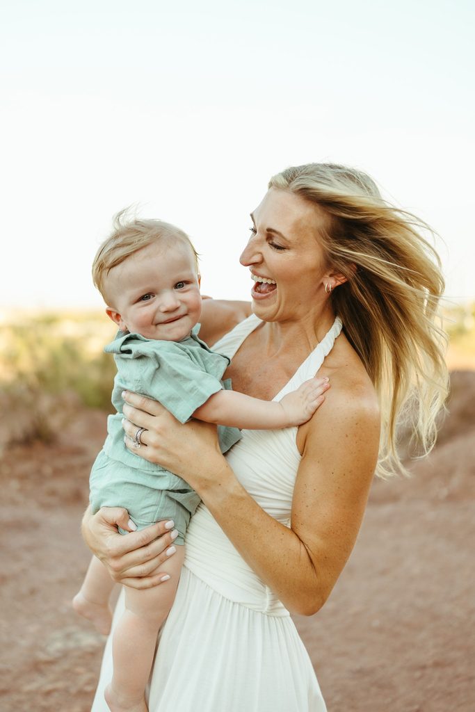 Phoenix family photographer capturing an effortless, candid connection between a mother and her laughing baby boy at Papago Park.