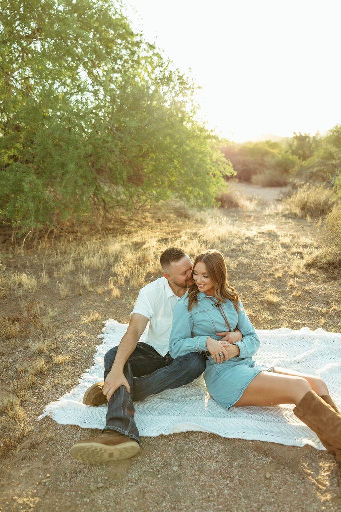 Superstition Mountains couples session featuring a romantic close-up of a couple lying together on a blanket in the Arizona desert.