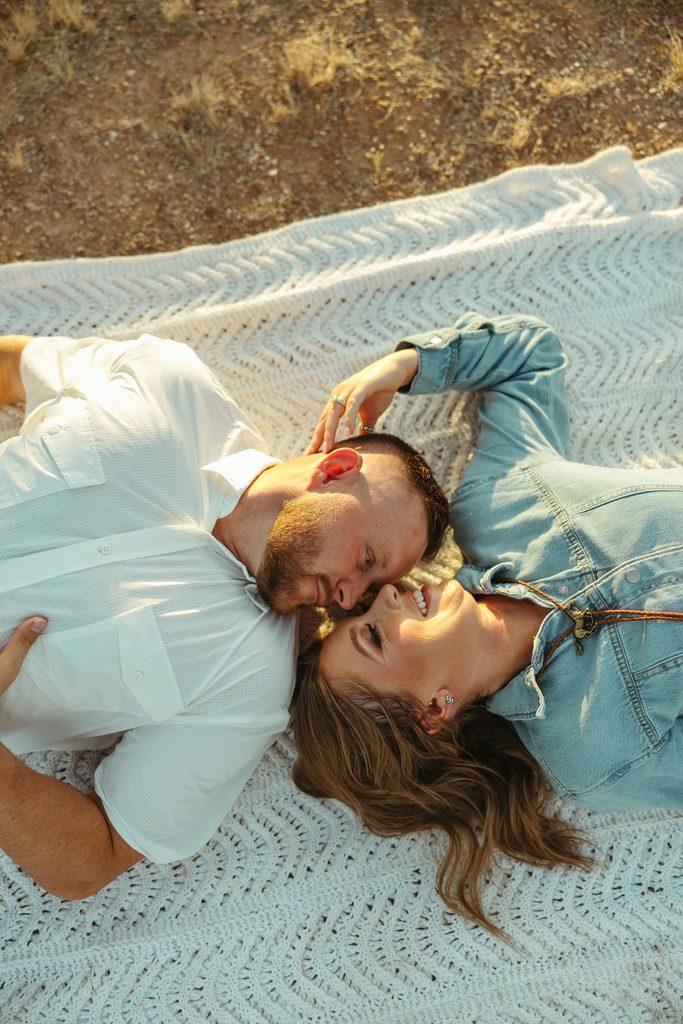 Arizona engagement photography featuring a couple standing together in the desert with the iconic Superstition Mountains visible in the background.