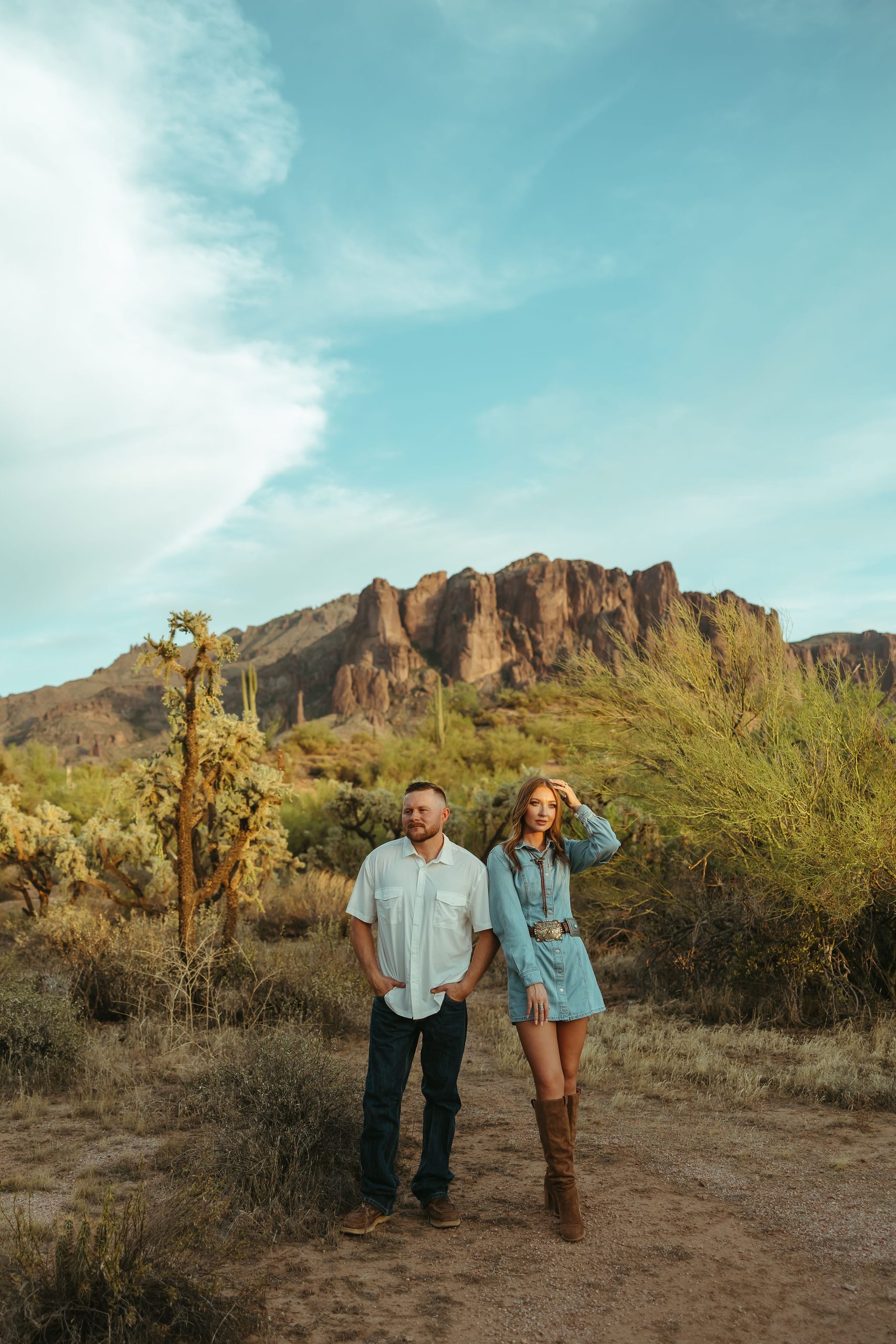couple standing in front of Superstition Mountains in Apache Junction