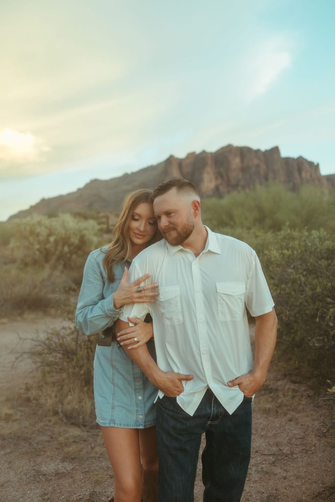 Superstition Mountains couples photography featuring an intimate portrait of a couple embracing on a desert trail surrounded by golden Arizona light.