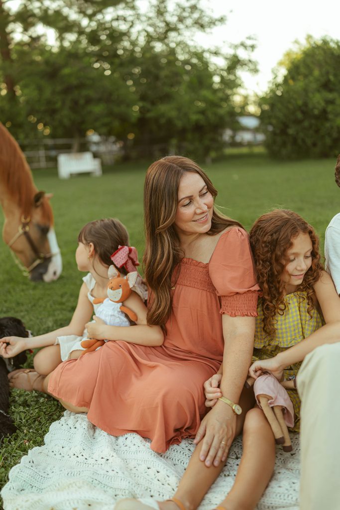 Gilbert family photographer capturing a natural mother and daughters portrait surrounded by the warm greenery of Floyd Family Farms.