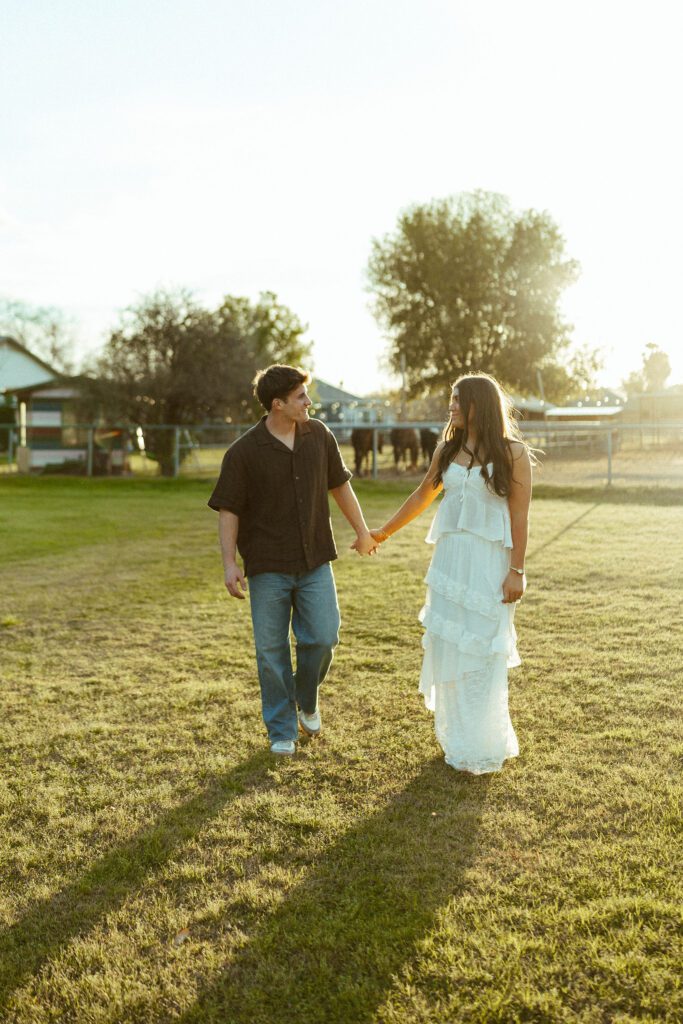 Couple walking hand in hand during a golden hour couples photography session in Gilbert, Arizona