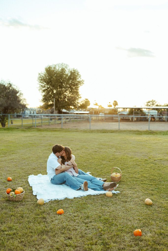 Couple relaxing together on a blanket during romantic outdoor couples photos in Gilbert, Arizona