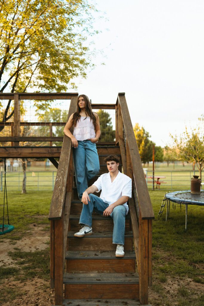 Couple posing together on wooden steps during a candid couples photography session in Gilbert, AZ