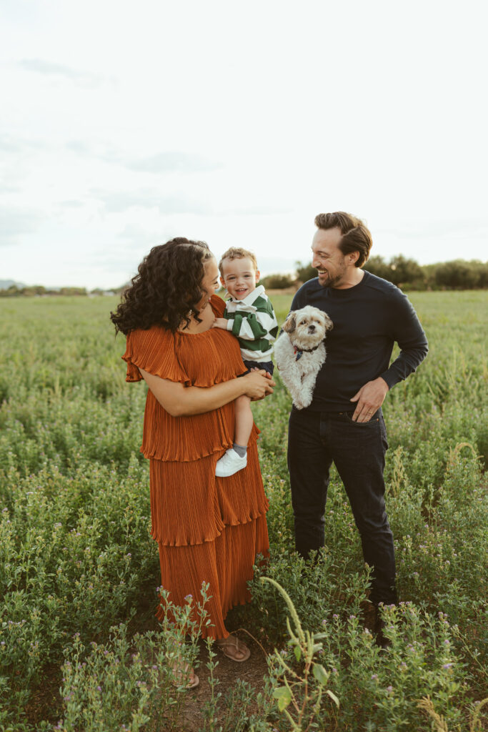 Mom holding her toddler during a golden hour family photography session in Queen Creek, AZ
