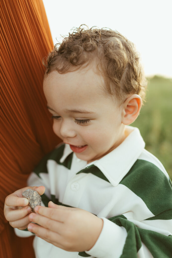 Toddler sitting on a blanket with his dog during family photography in Queen Creek, Arizona