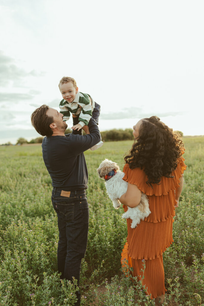 Parents kissing their toddler during candid family photos in Queen Creek, Arizona