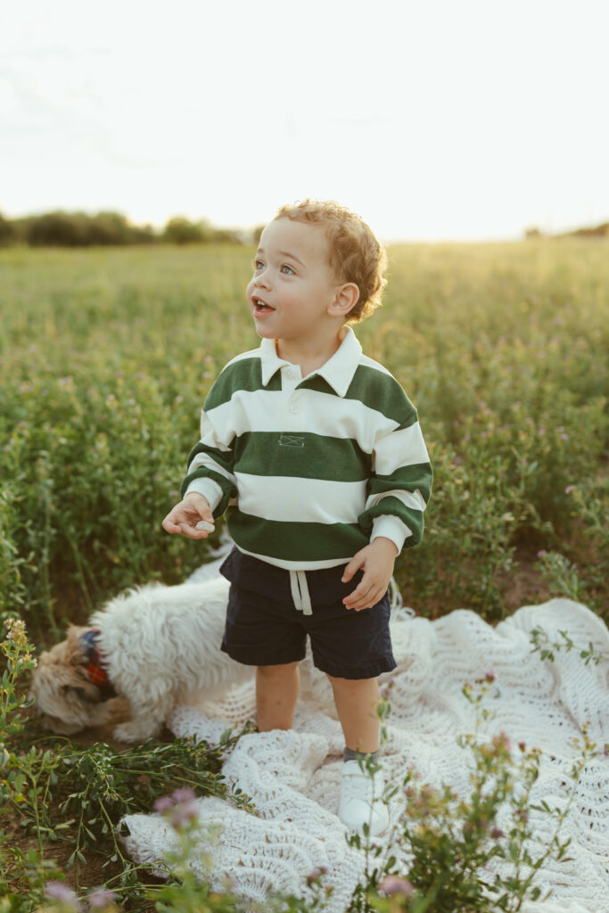 Toddler exploring an open field during family photography in Queen Creek, Arizona