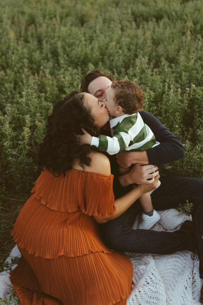 Toddler standing with the family dog during an outdoor Queen Creek family photography session