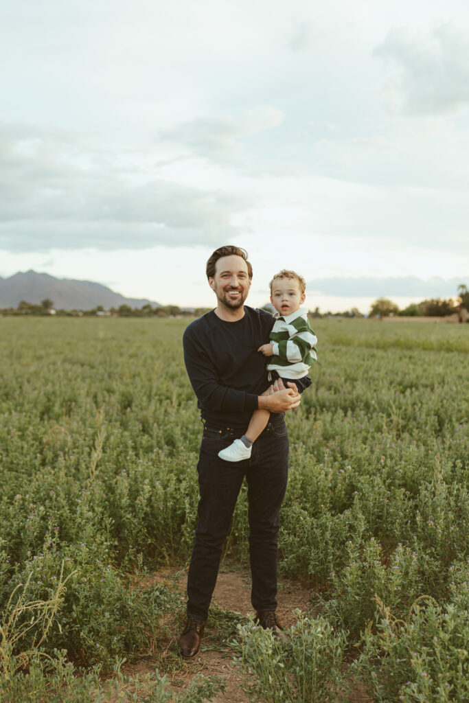 Parents playing with their toddler during golden hour family photos in Queen Creek, AZ